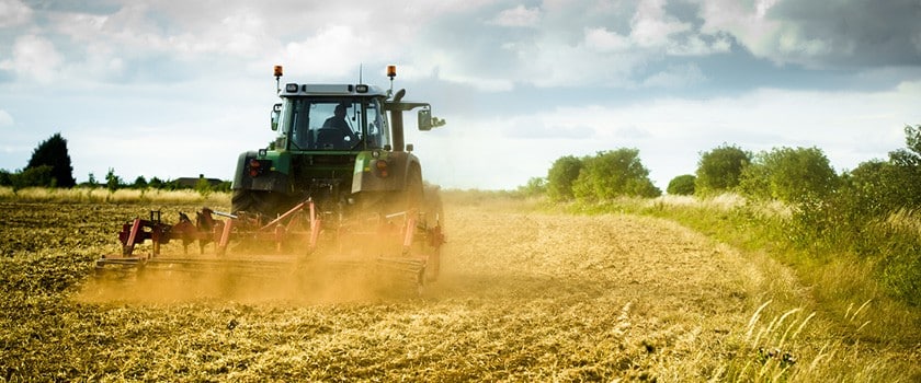 tractor mowing down field